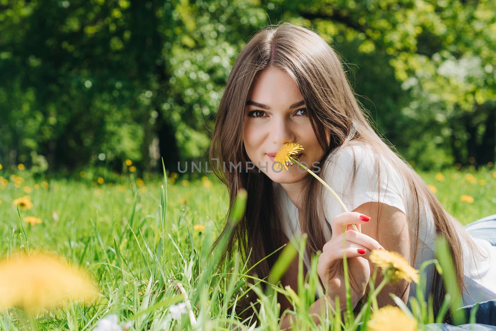 Woman laying on grass in park by ALotOfPeople