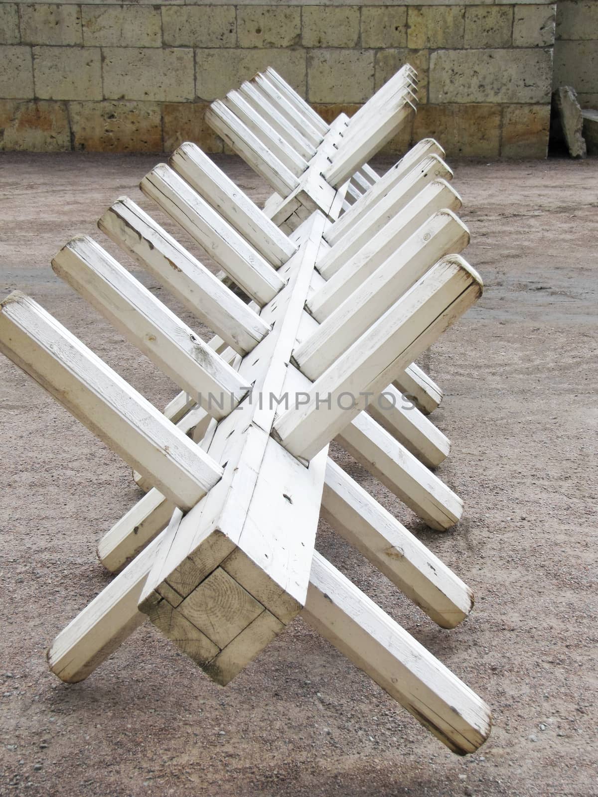 light fortification slingshot made of wood painted in white colour on stone wall background