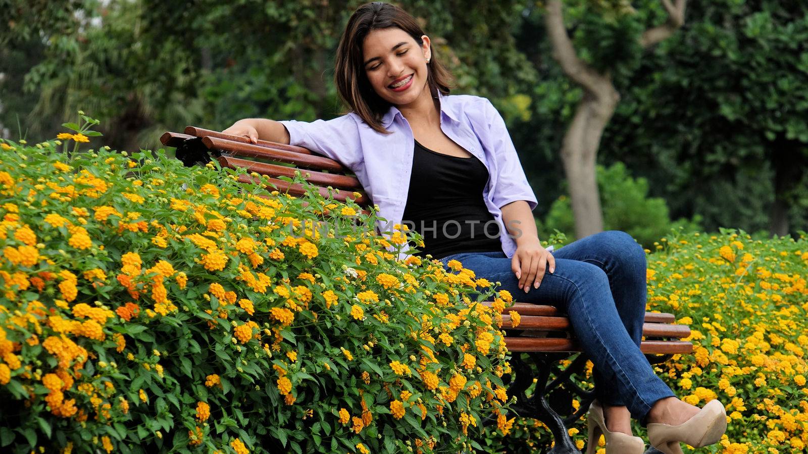 Young Girl And Happiness Sitting In Park