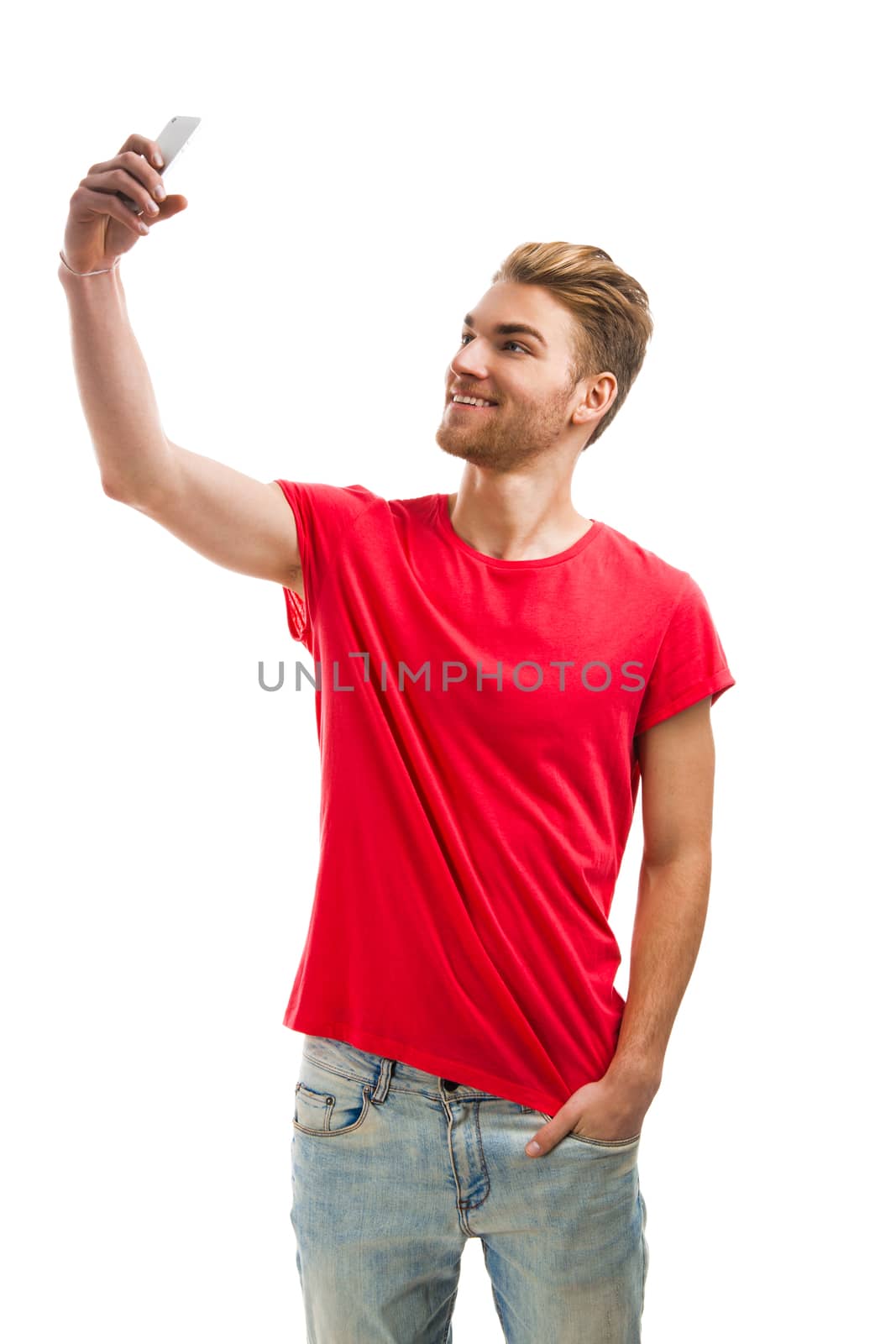 Handsome young man making a selfie, isolated over a white background