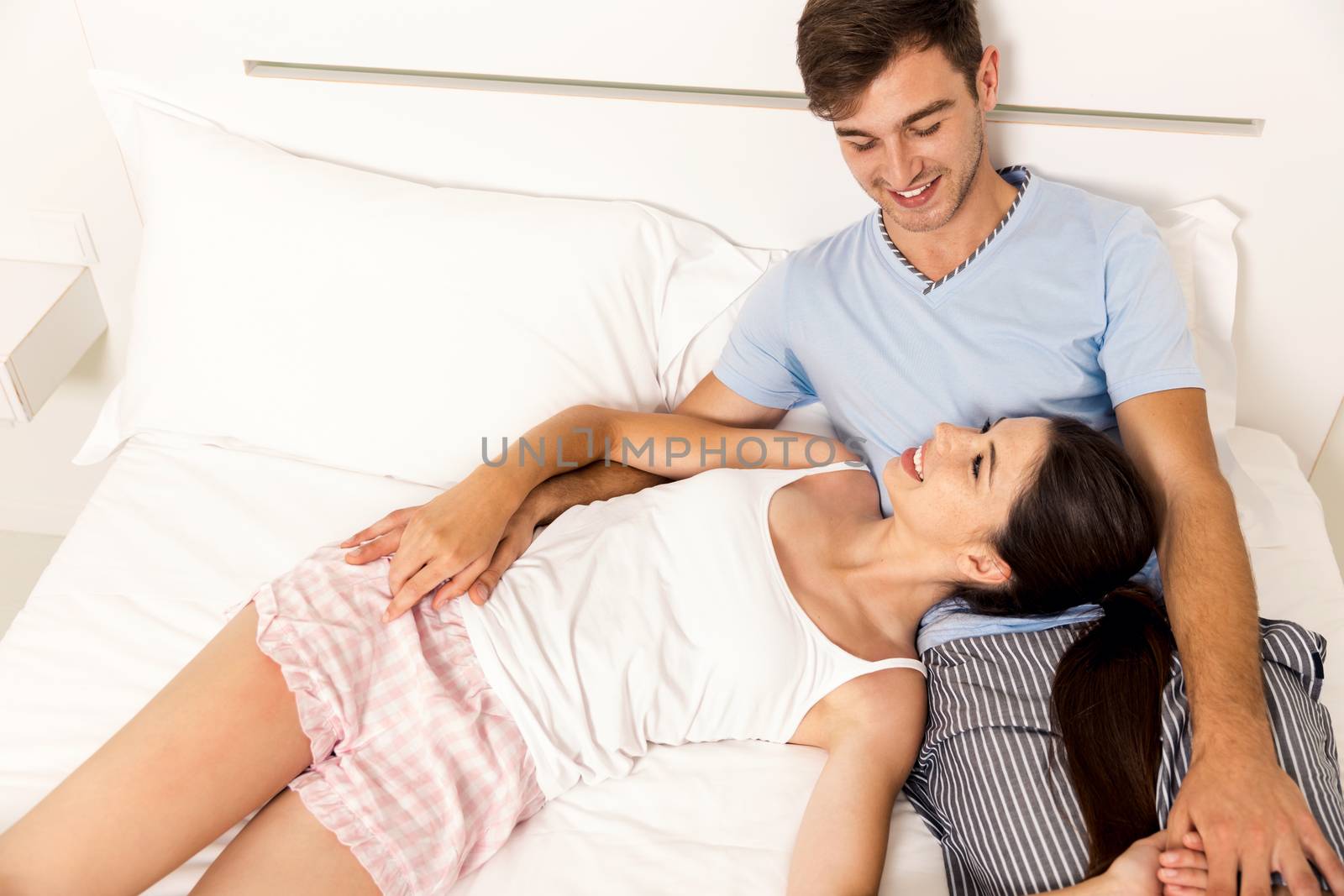 Young couple dating on a hotel bedroom