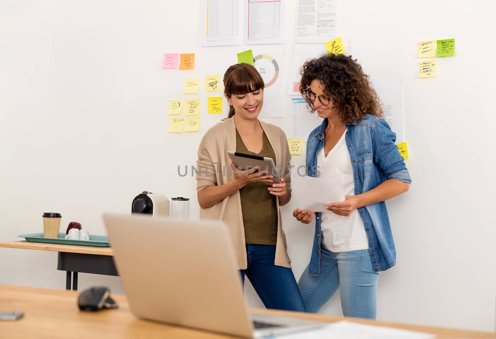 Shot of two businesswoman working together in an office