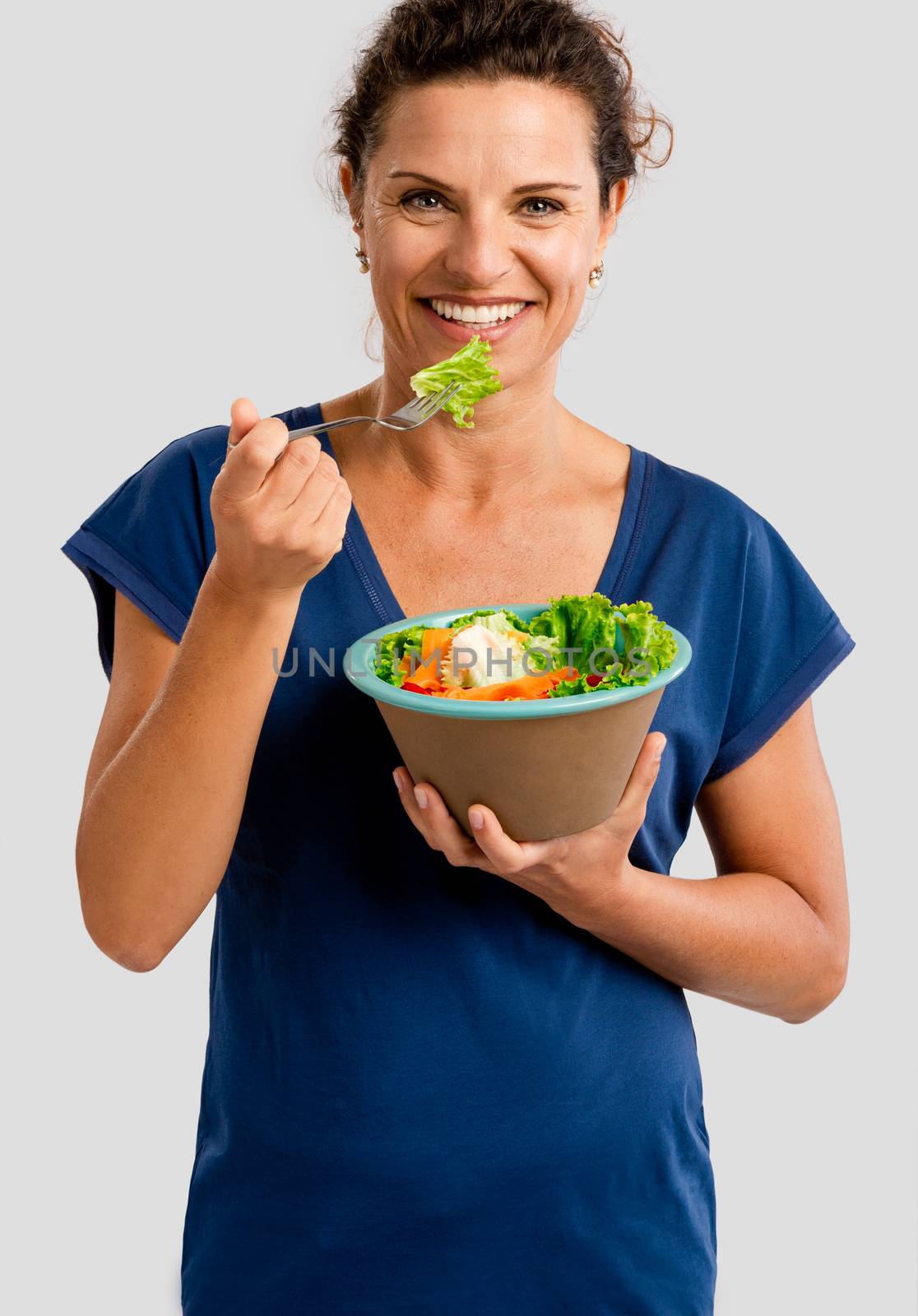 Portrait of a middle aged woman eating a healthy salade