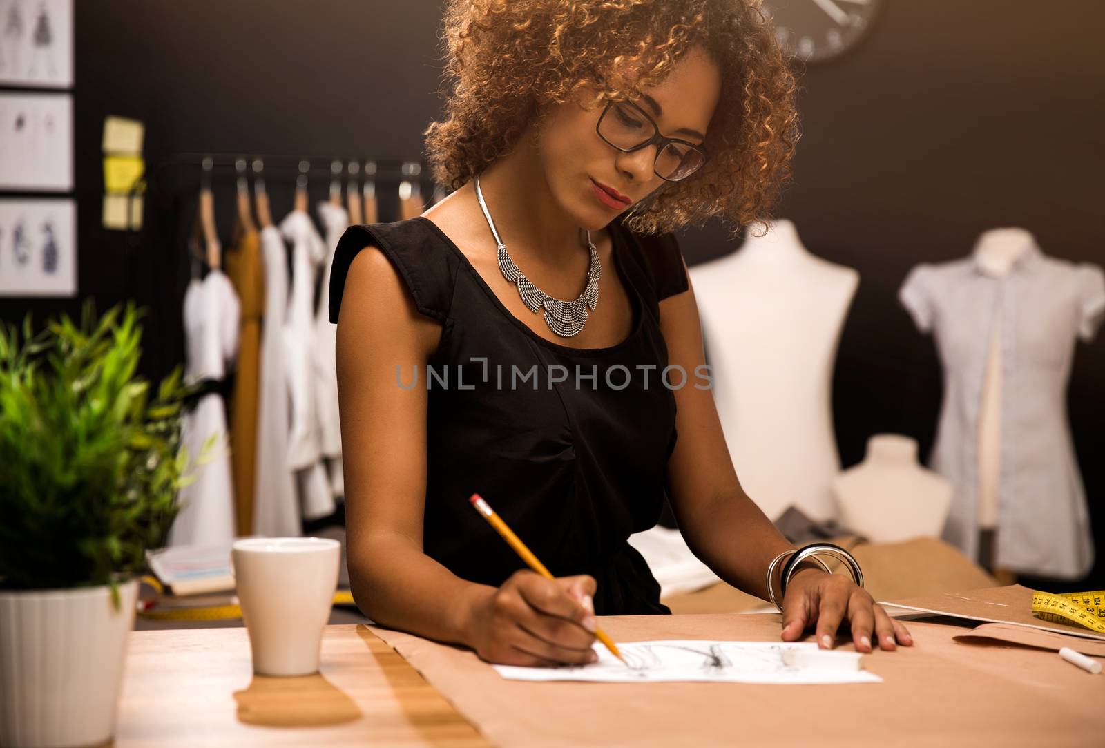 A young fashion designer working on her atelier