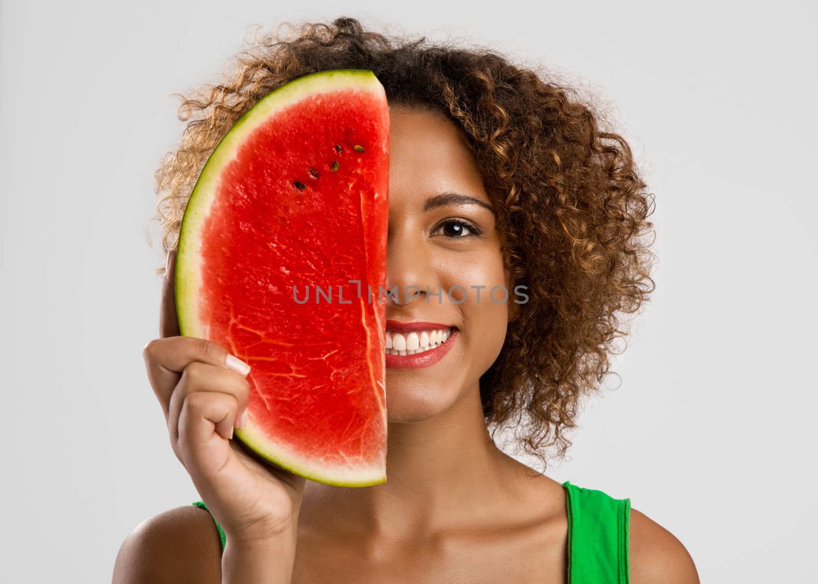 Beautiful African American woman olding a watermelon fruit on her hands