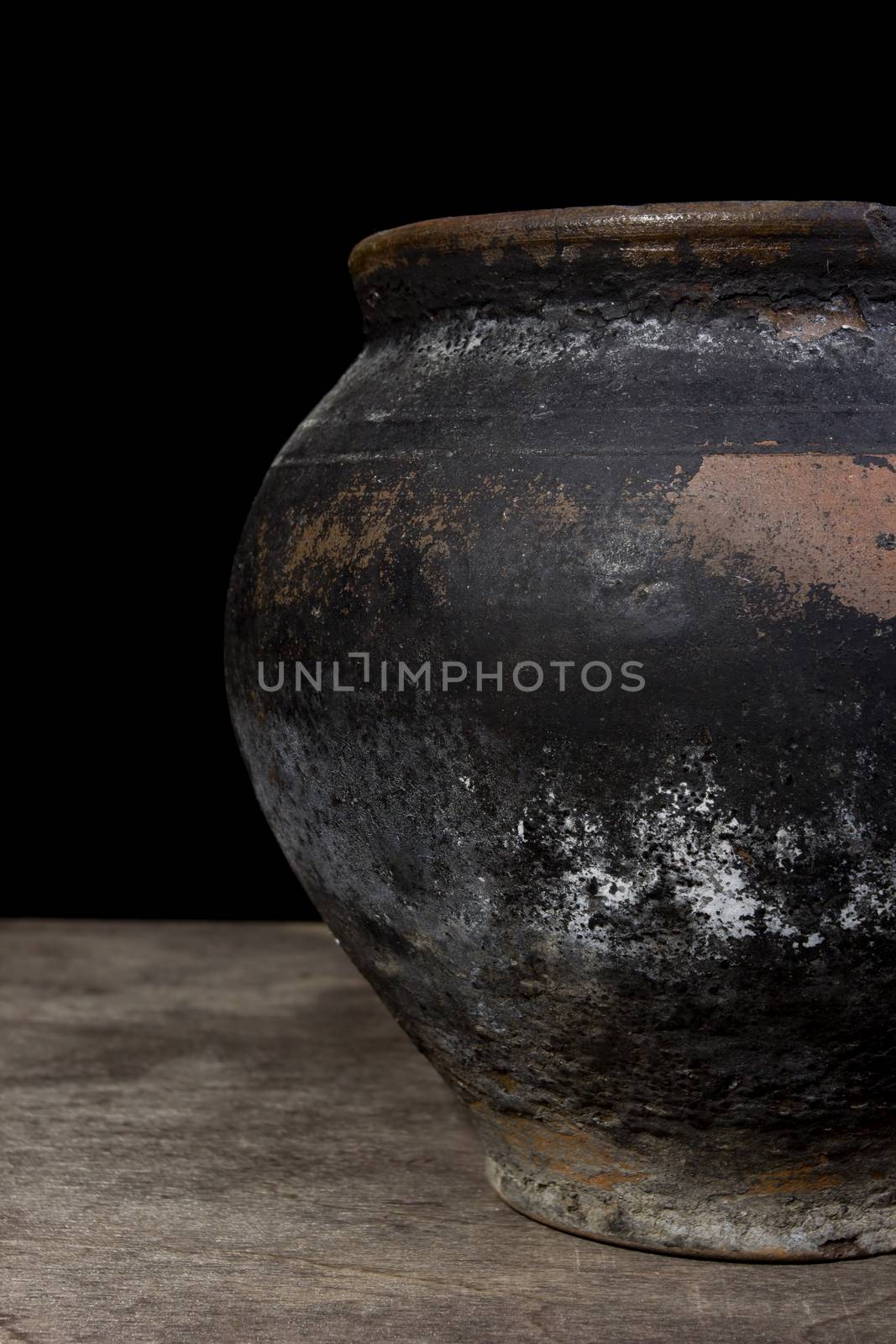 Fragment of antique pottery on a black background