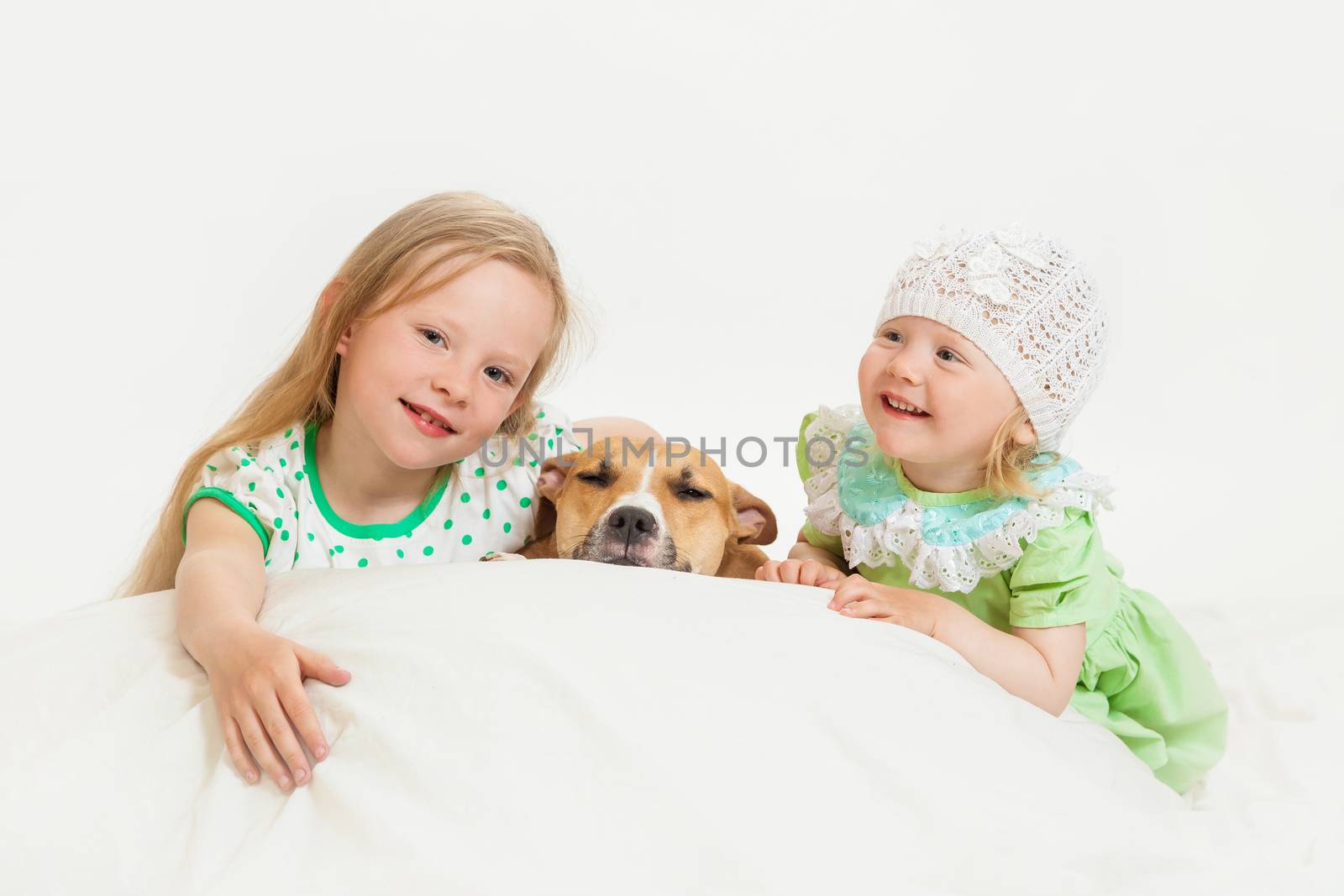 two little girls and dog on the isolated background