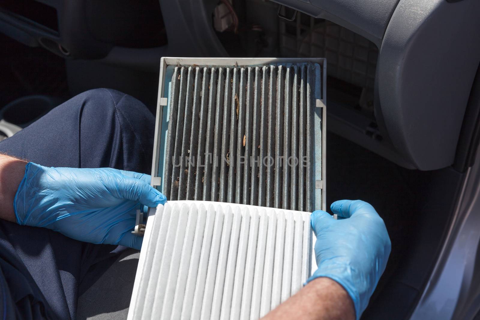 Replacing the cabin air filter. Old and new cabin air filter for car.