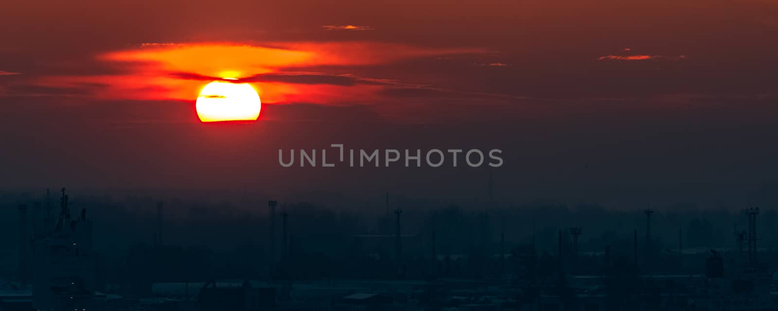 Hot orange sunset over the river. Urban landscape