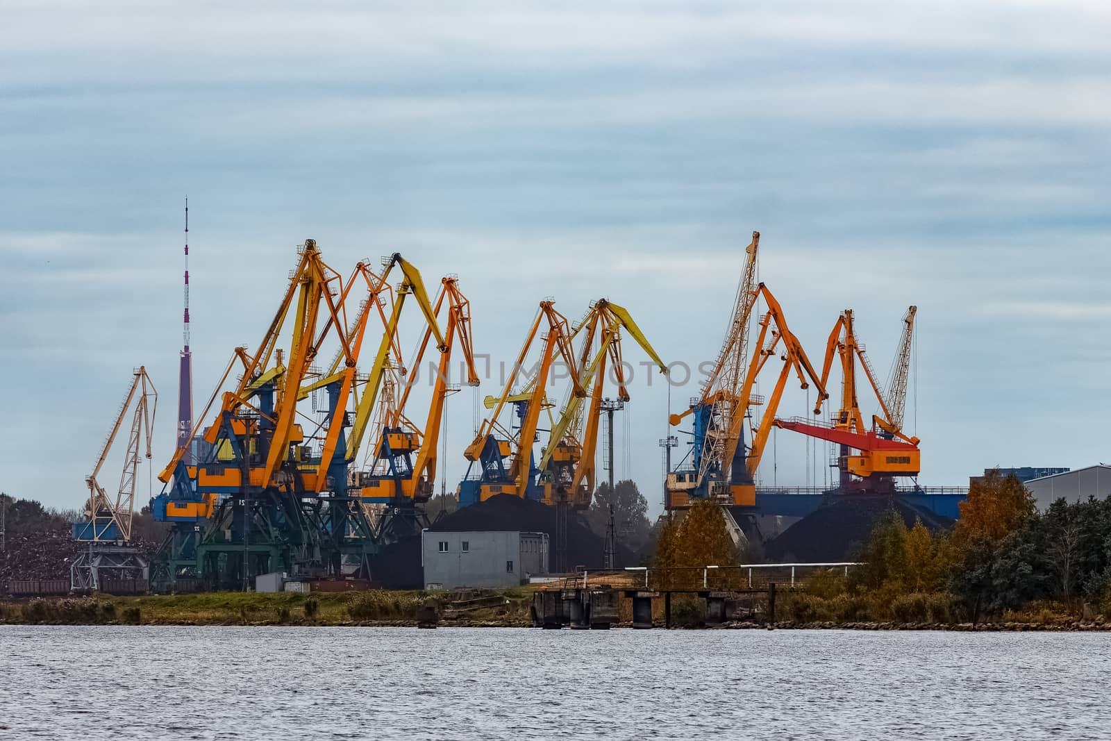 Yellow cargo cranes in the port of Riga, Europe