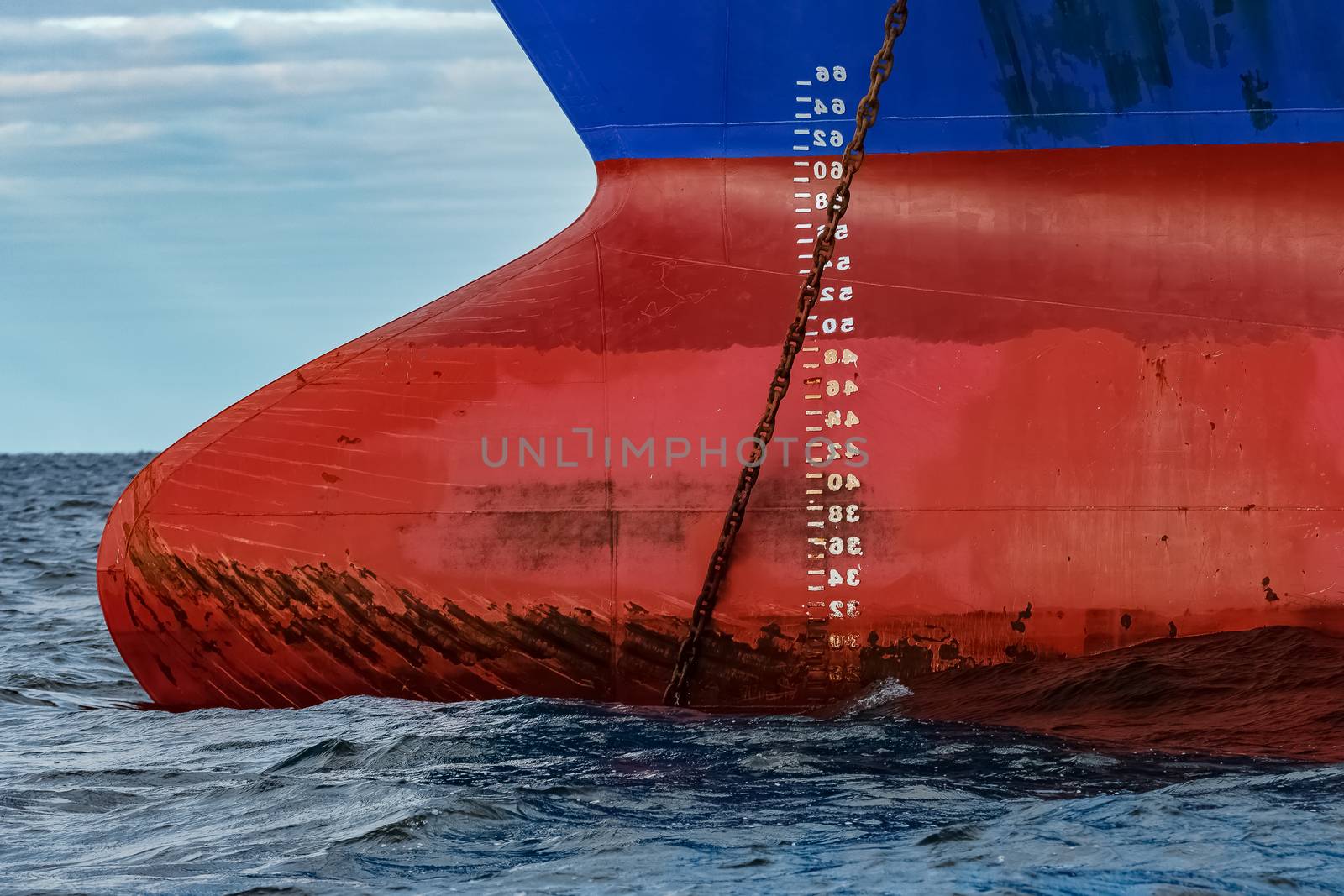 Blue cargo ship moored in still Baltic sea water