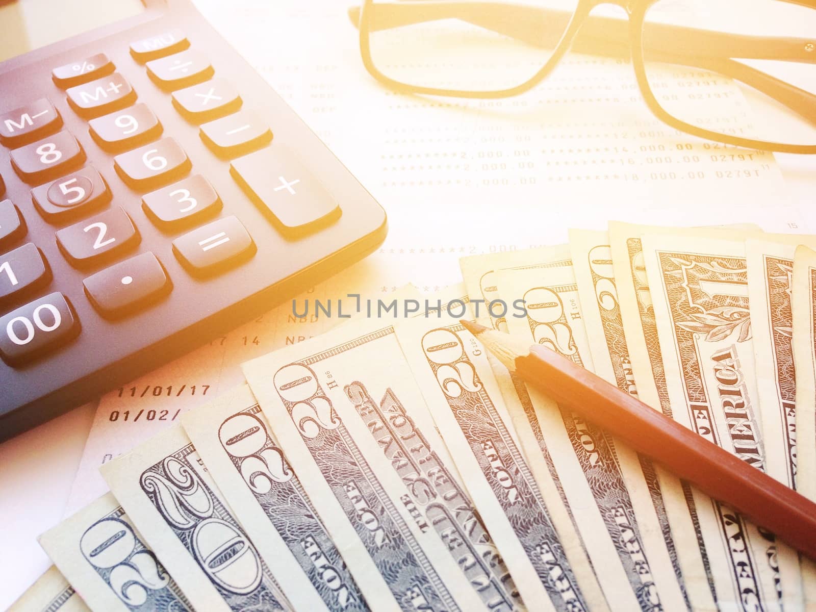 Business, finance, savings, banking or  loan concept : Pencil, eyeglasses, calculator, money and savings account passbook or financial statement on white background