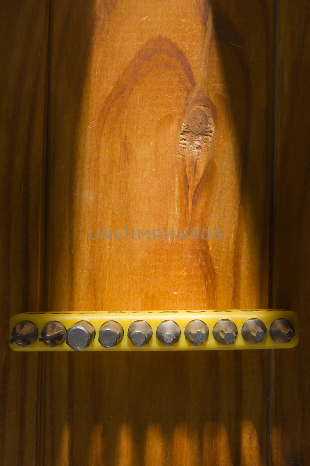 Set of screwdriver bits on a wooden background