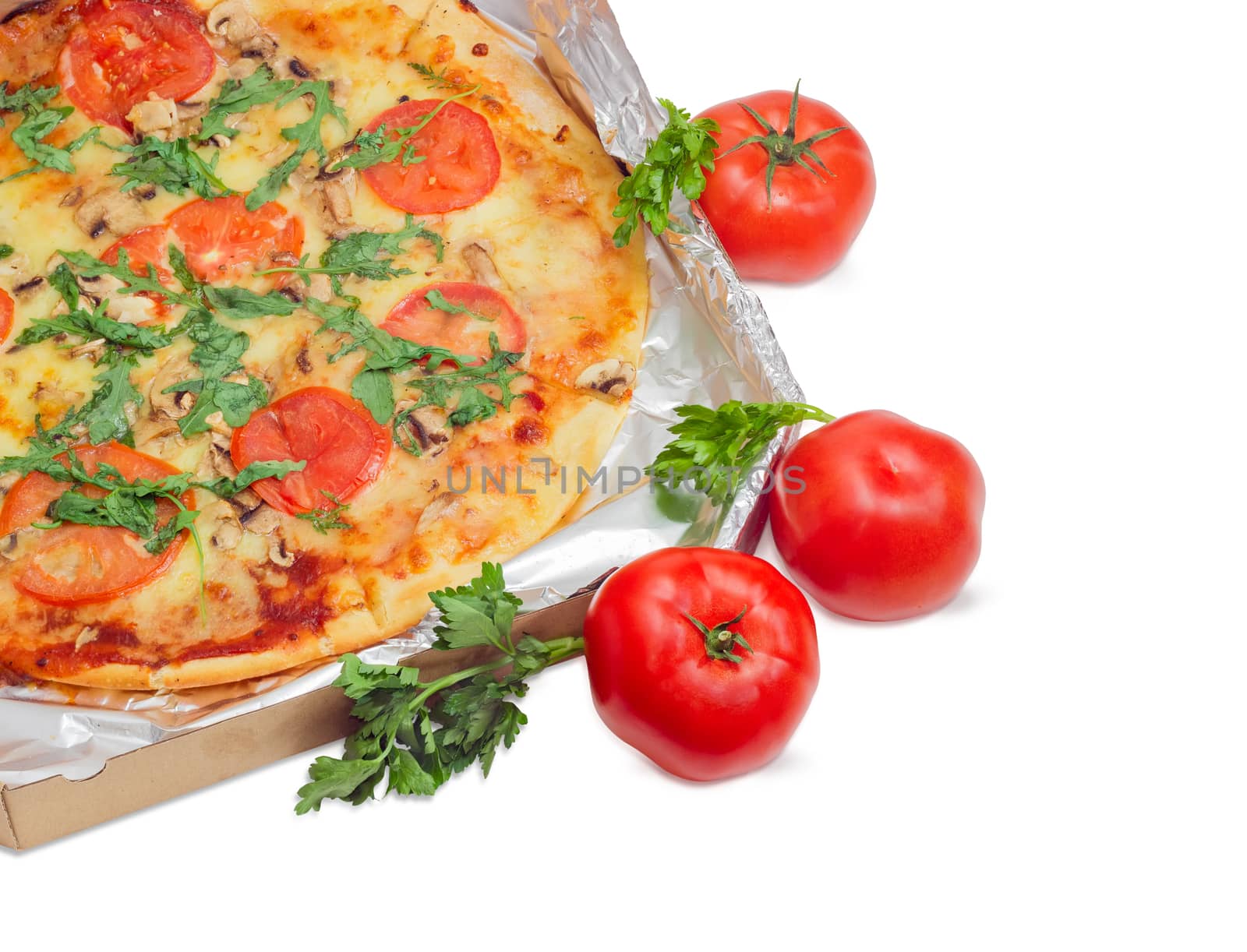 Fragment of the cooked round pizza with tomatoes, mushrooms and arugula wrapped in aluminum foil in the open cardboard box and three fresh tomatoes beside on a light background
