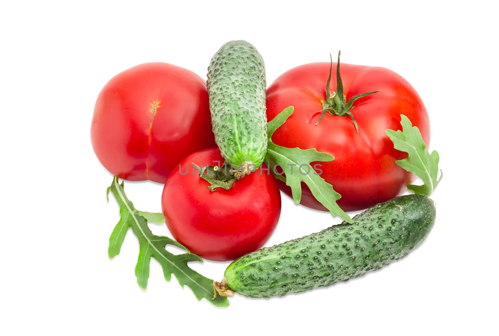 Three red tomatoes different sizes, two cucumbers and arugula leaves closeup on a light background
