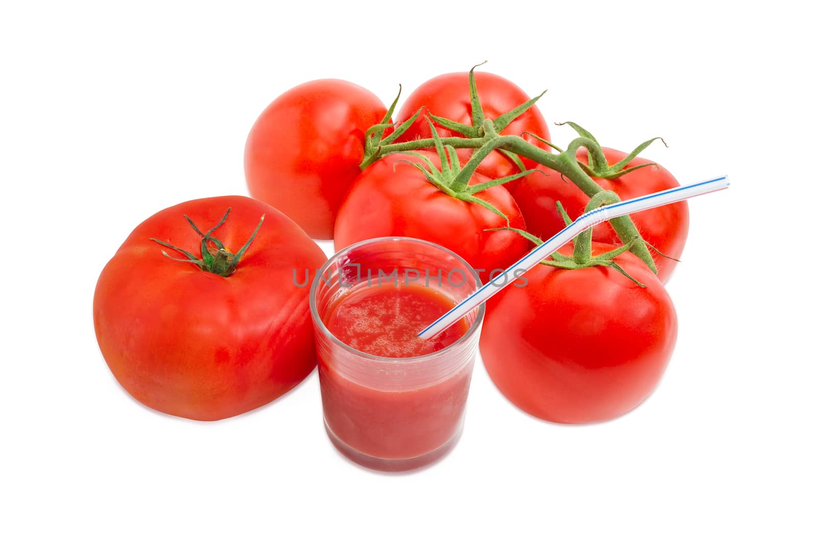 One tomato, branch of the fresh ripe tomatoes and tomato juice in glass with bendable drinking straw on a light background
