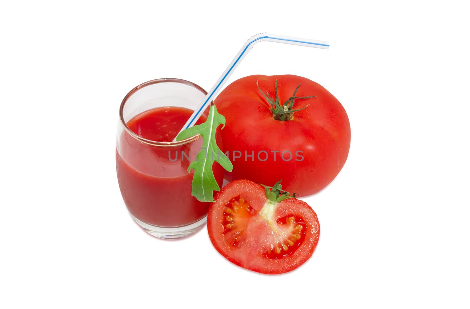 One whole and one half of the fresh ripe tomatoes, tomato juice in glass with bendable drinking straw and arugula leaf on a light background
