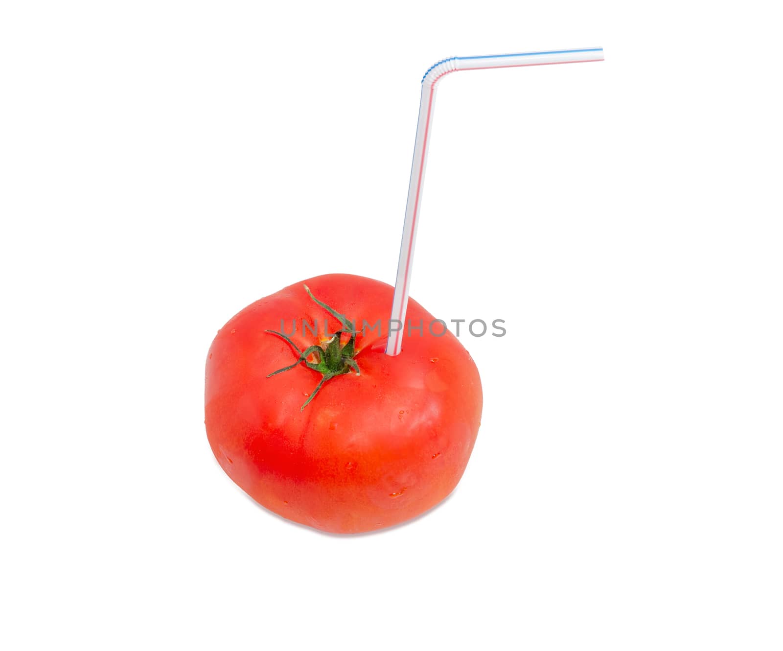 Big fresh ripe tomato and bendable drinking straw inserted into it on a light background
