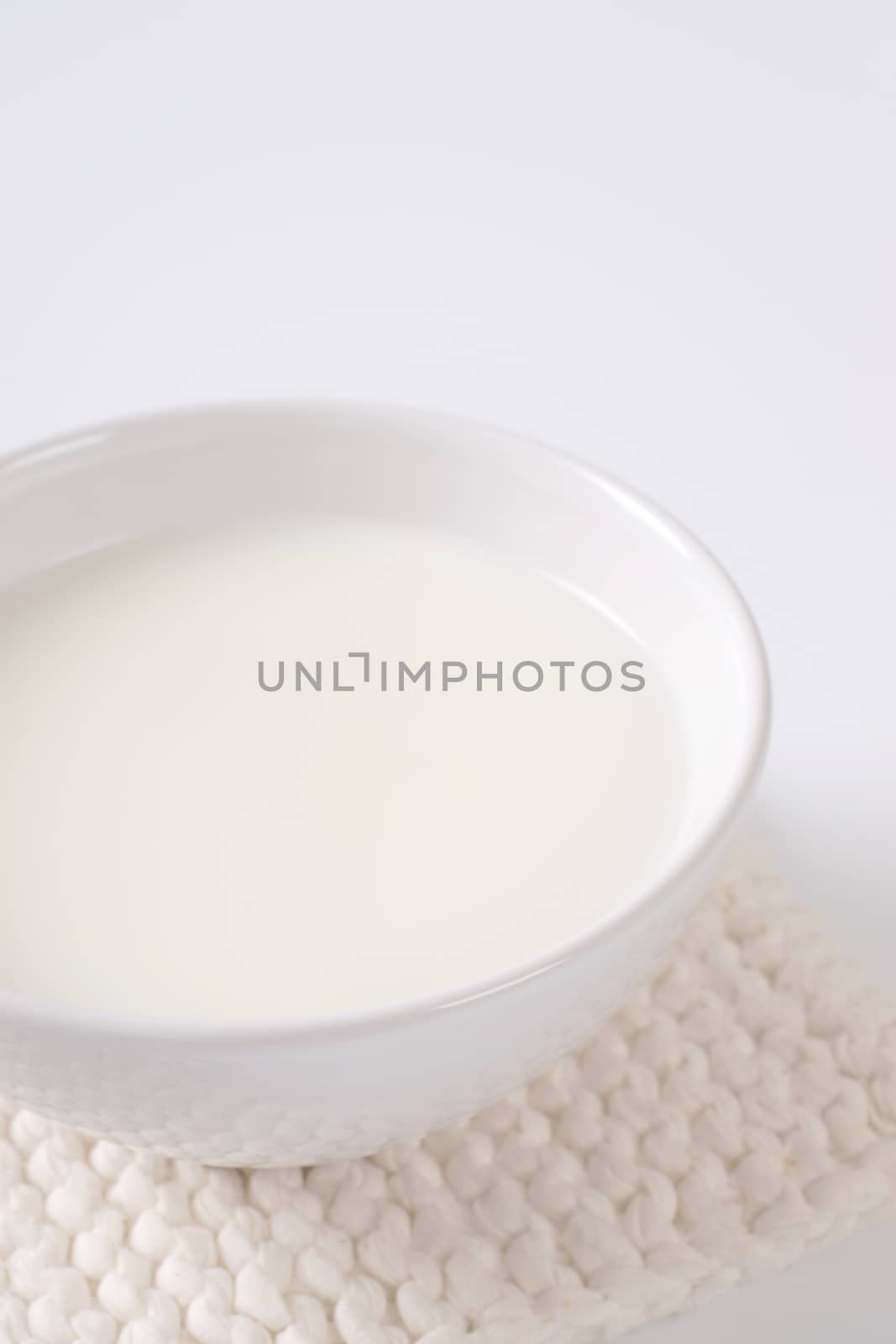 bowl of fresh milk on white table mat