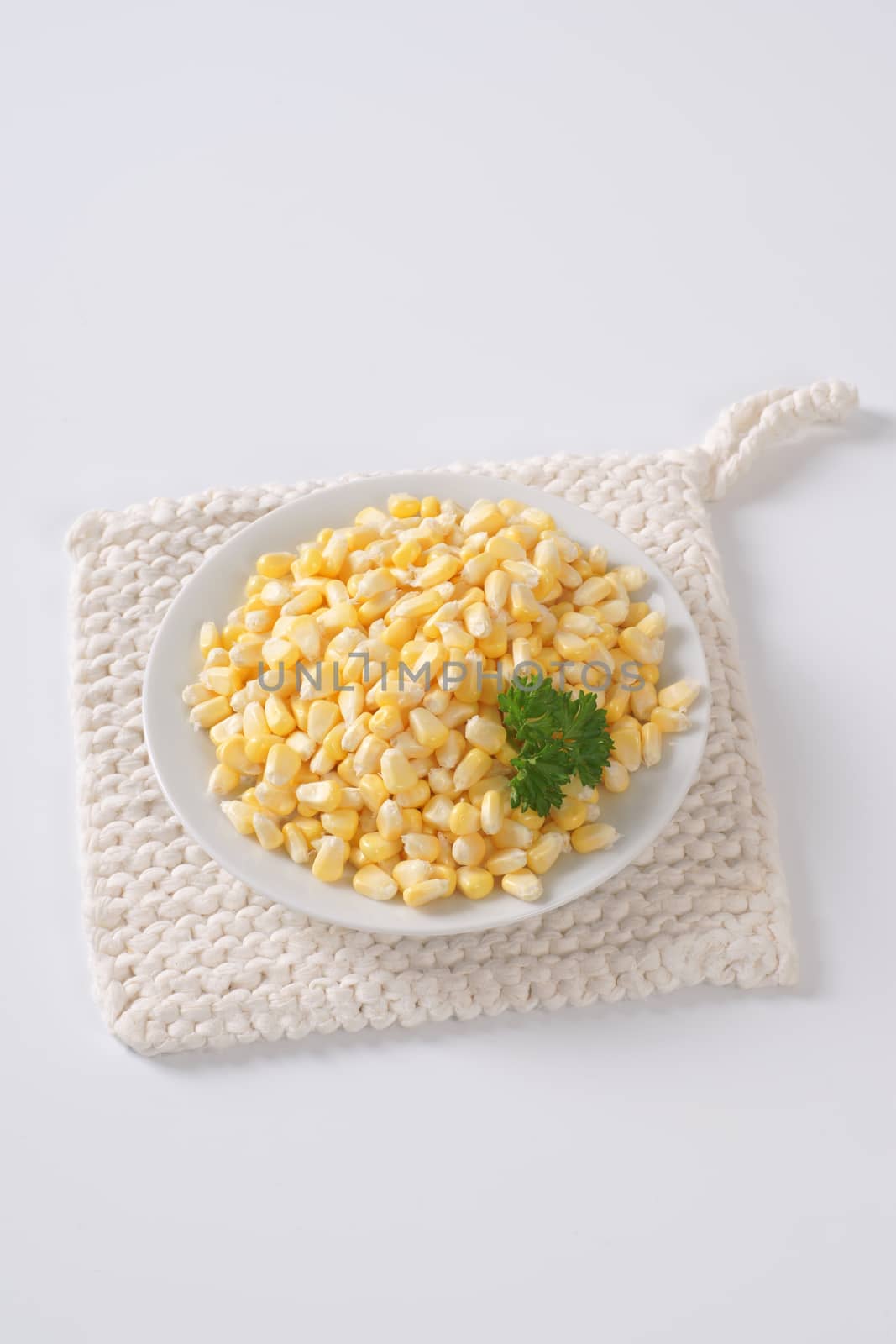 plate of sweet corn kernels on white table mat