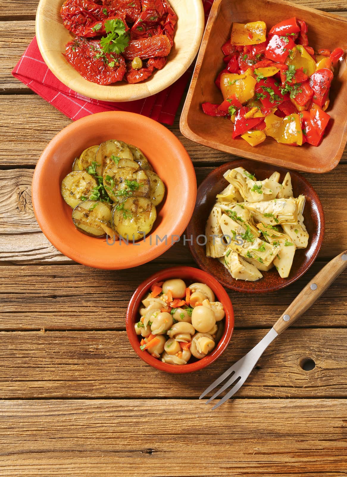bowls of assorted pickled vegetables on wooden background