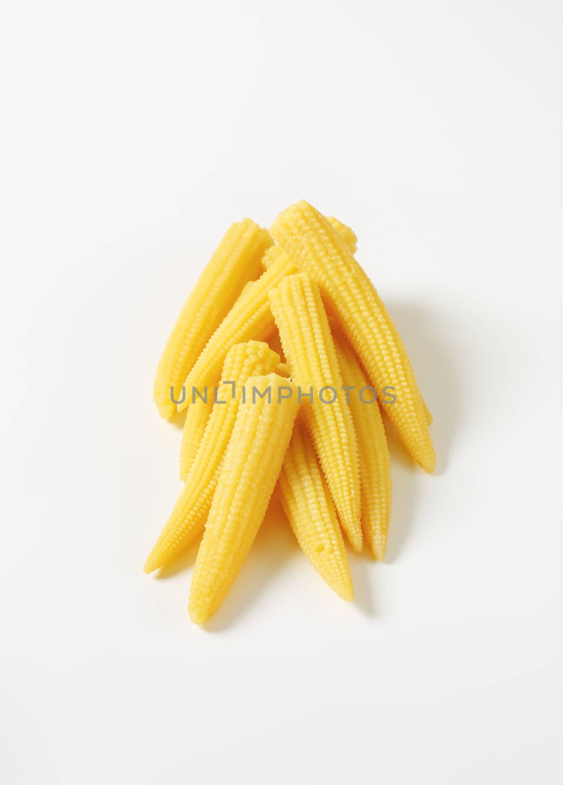 heap of sweet baby corn on white background