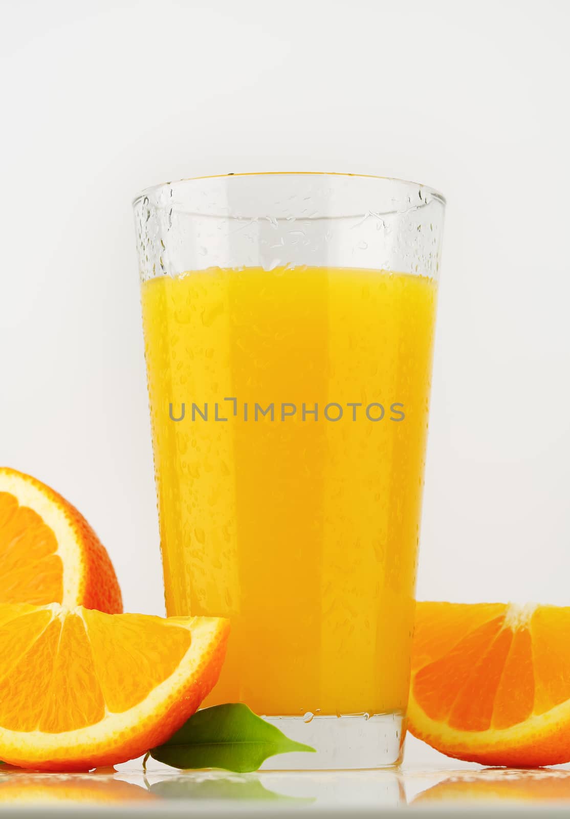 glass of orange juice on white background - close up