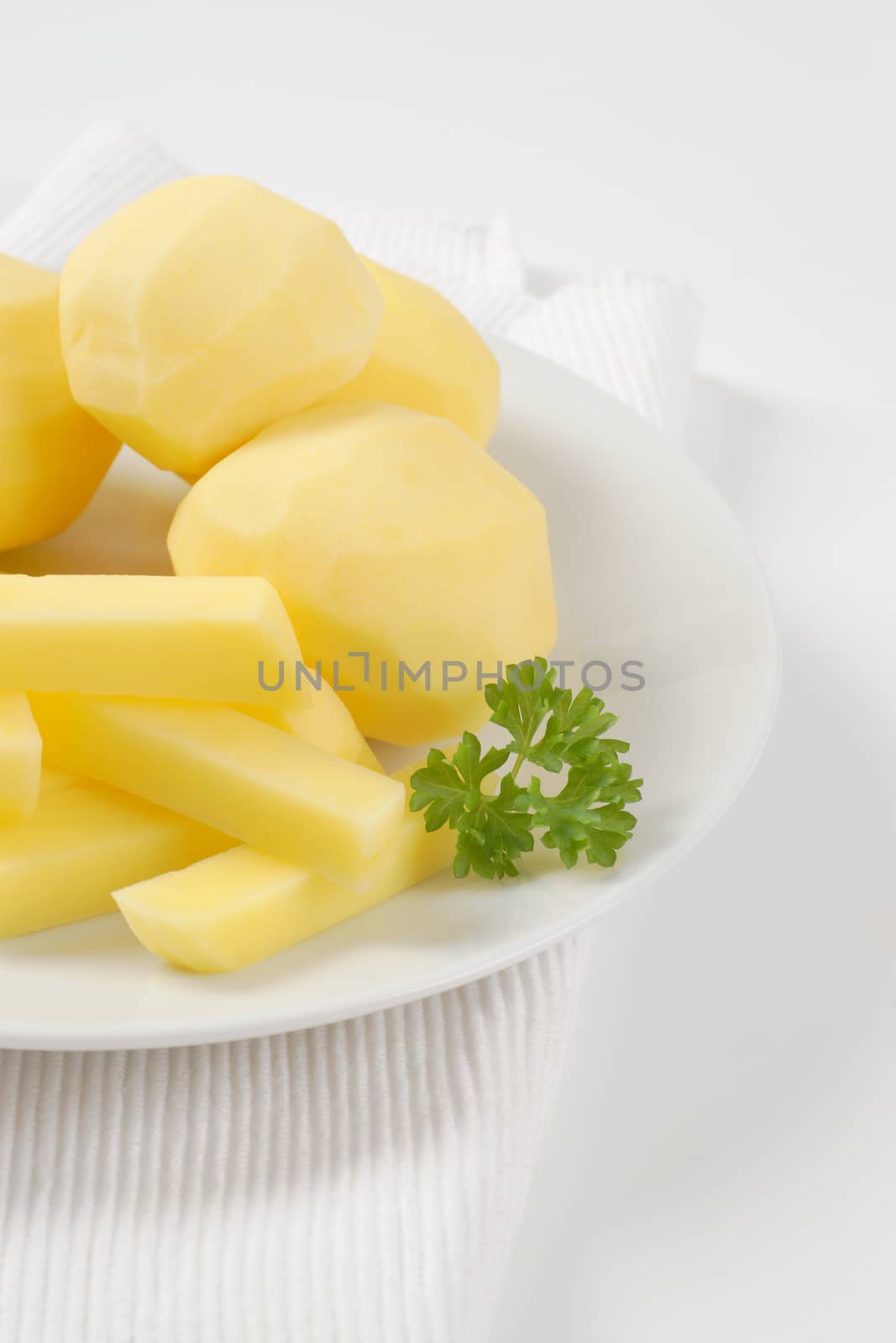 raw whole and chipped potatoes on plate