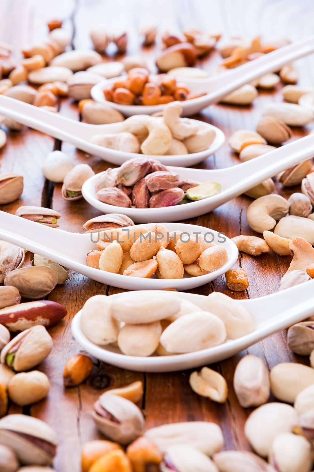Mix of  nuts over a rustic table in backlit
