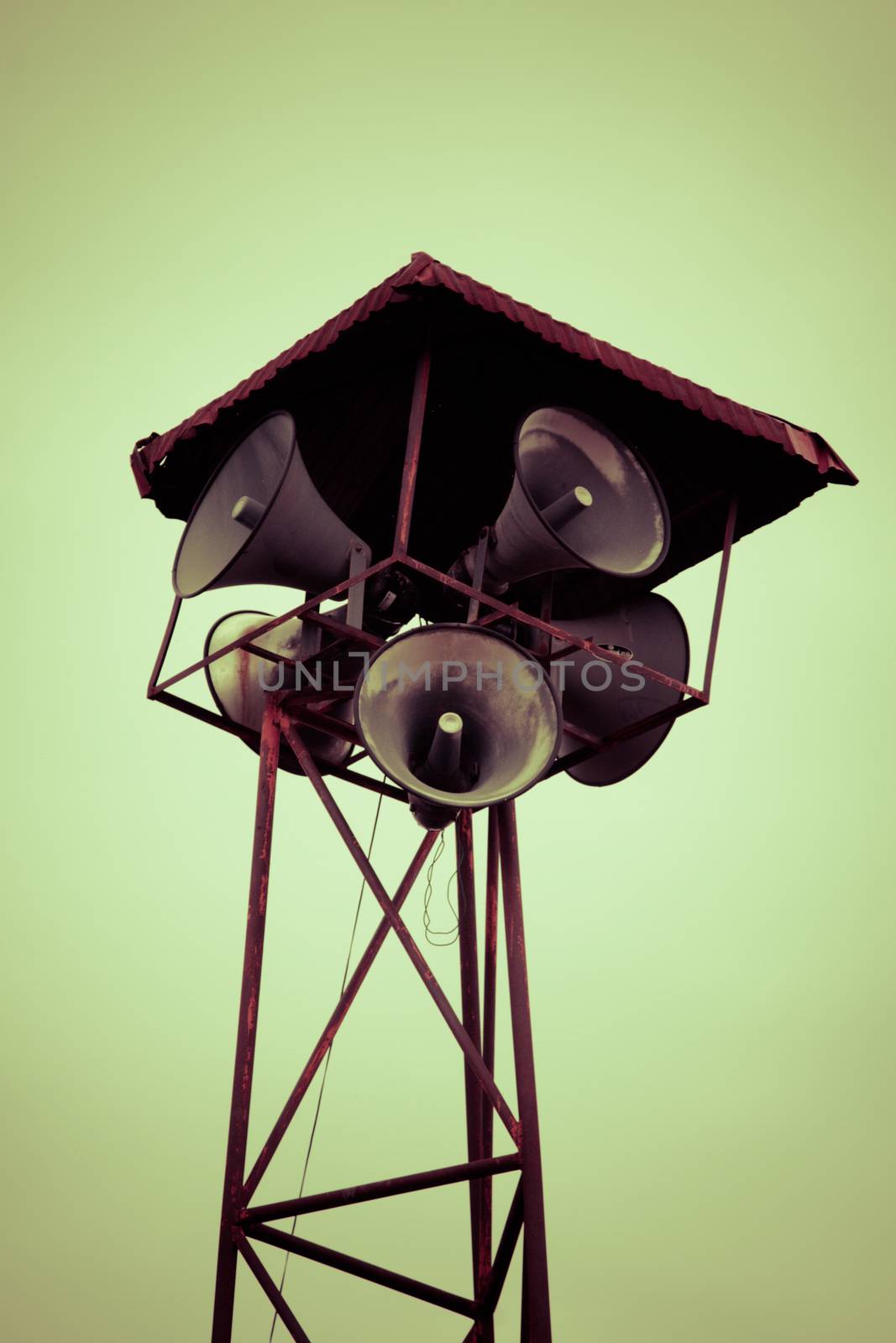 Old public loudspeakers broadcast on high tower with long distance tower