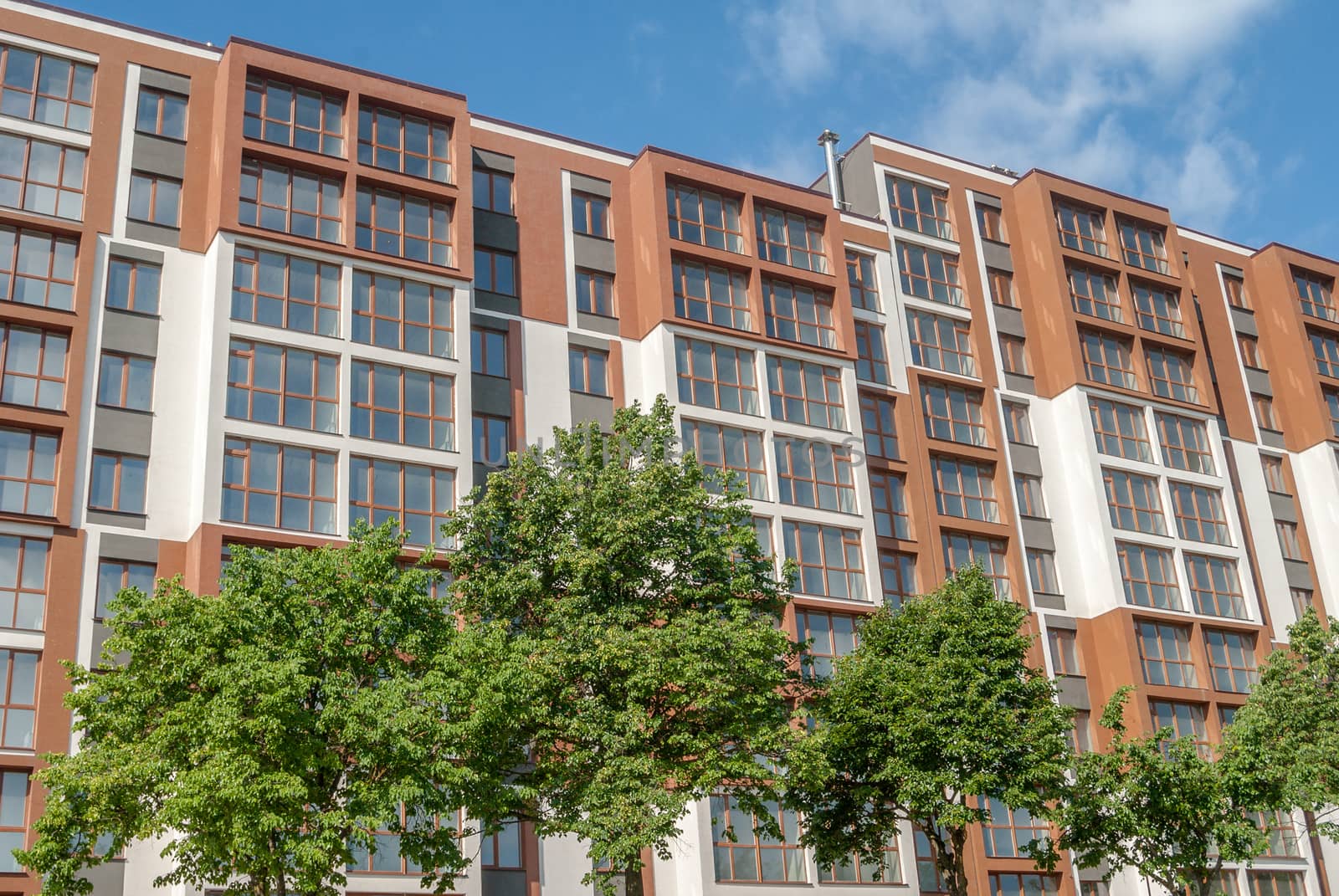 kind of a new multistorey brick residential building on a sunny day