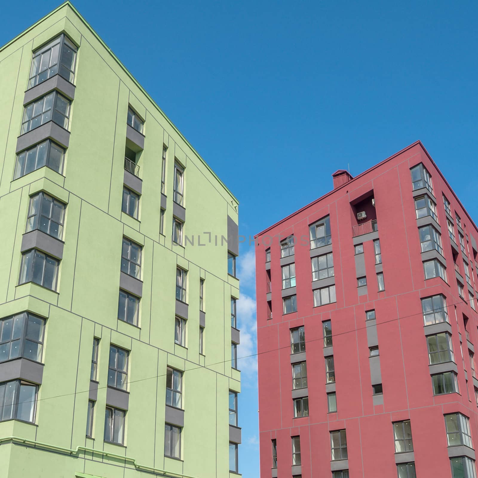 kind of a new multistorey brick residential building on a sunny day