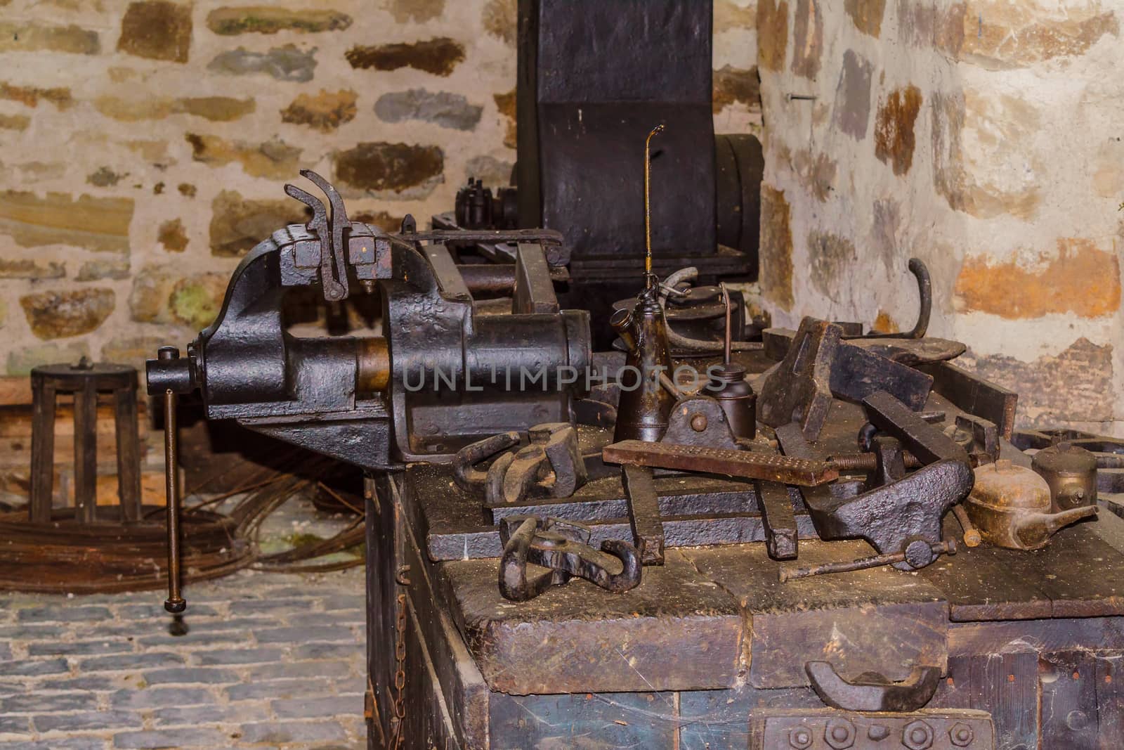 Old workbench with various tools and machines.