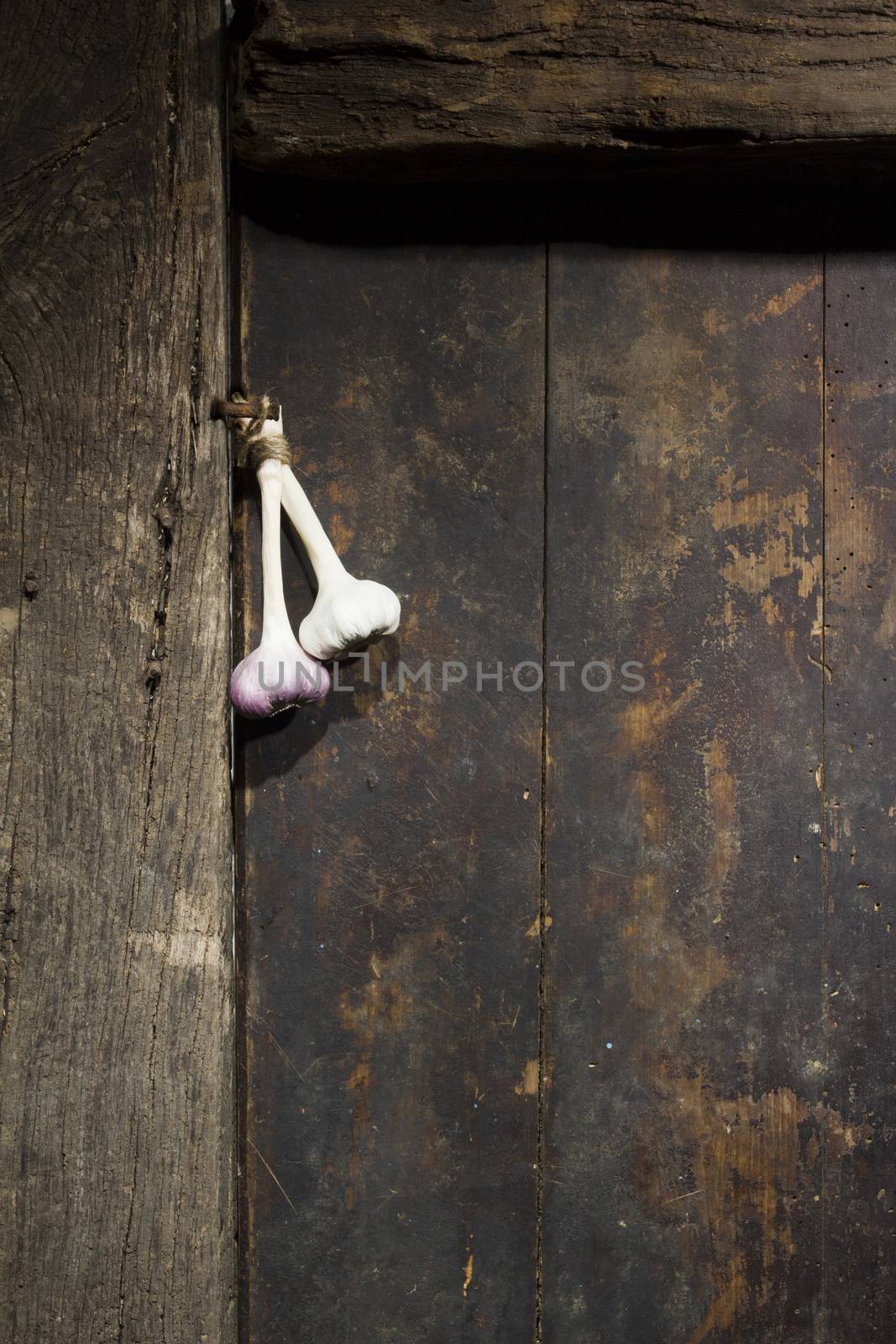 Bunch of garlic on an old wooden door