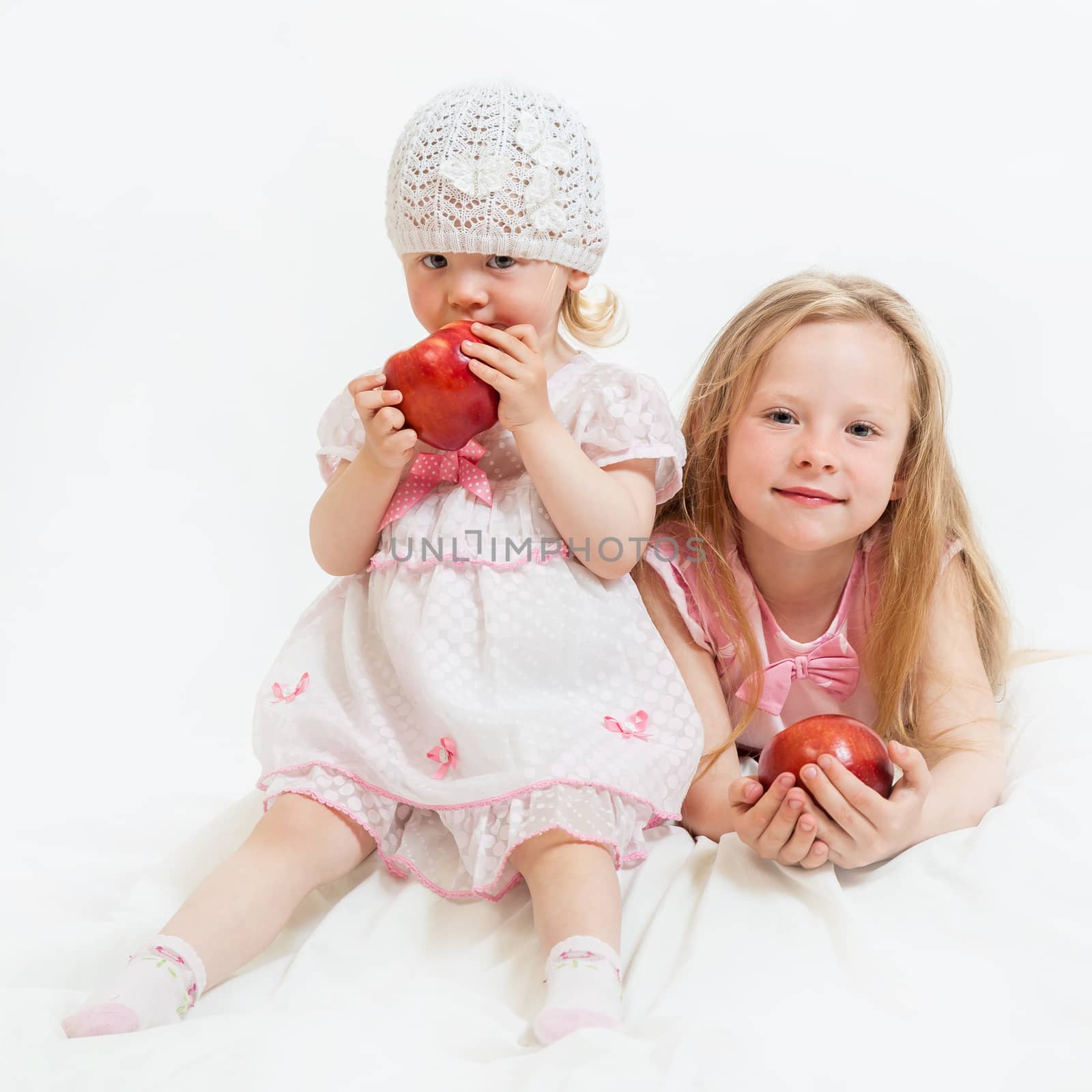 two little girls sit by sveter