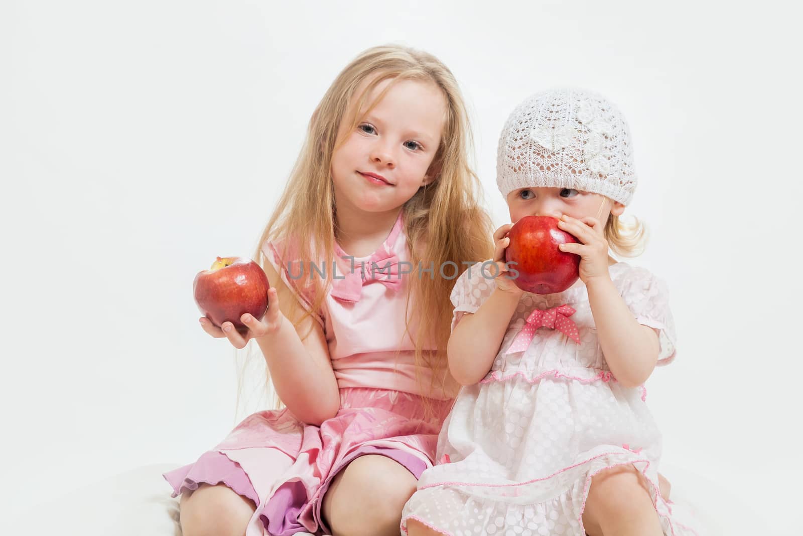 two little girls sit by sveter