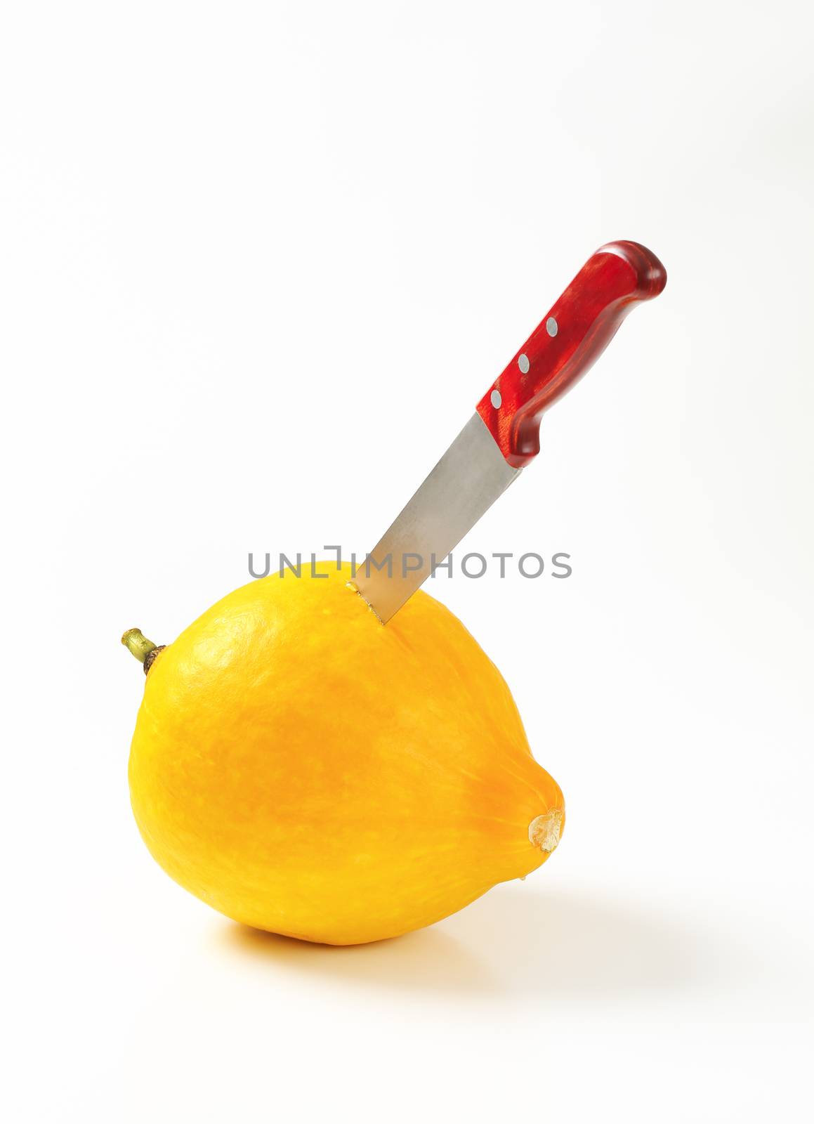 Ripe yellow summer squash and kitchen knife