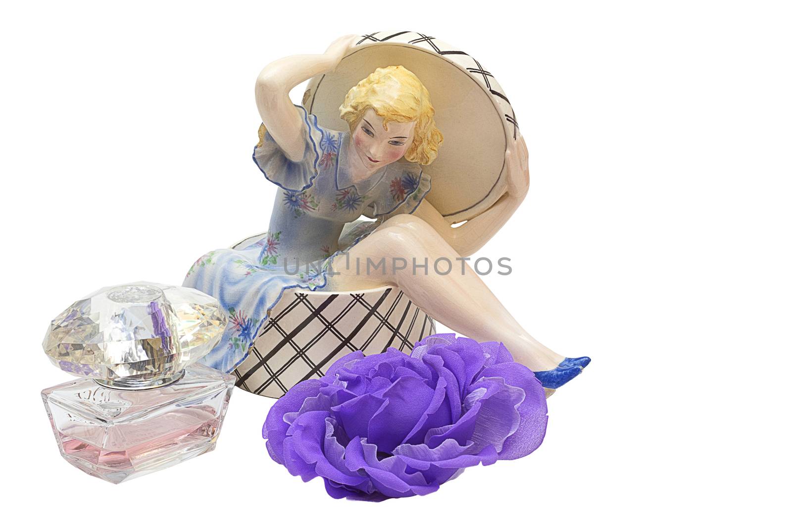 Old porcelain figurine of a ballerina and artificial flower on a white background
