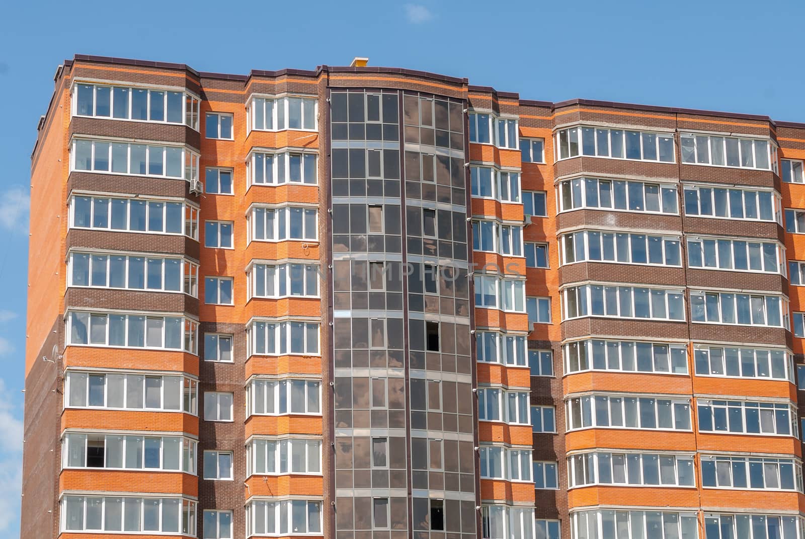 kind of a new multistorey brick residential building on a sunny day