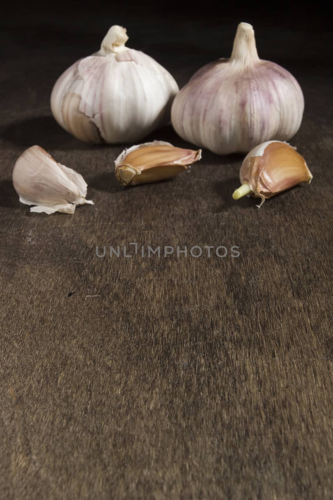 Ripe fresh garlic on a brown wooden table