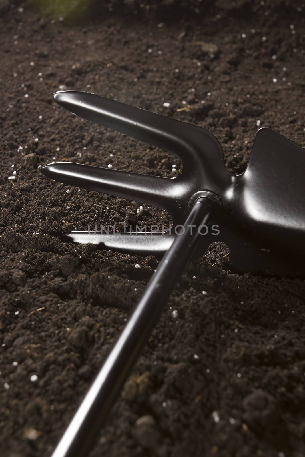 New garden tool in the soil close-up