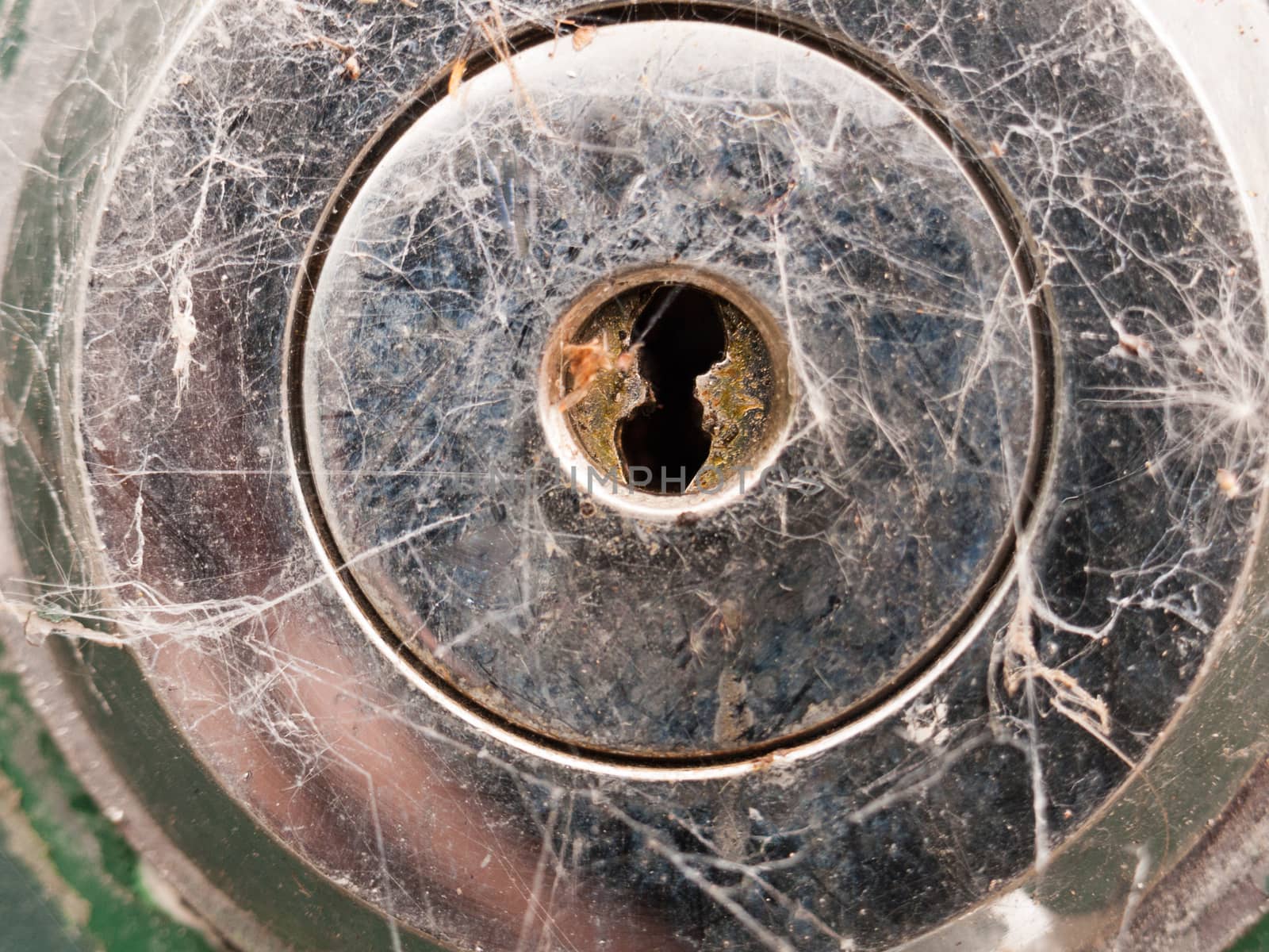 a silver metal key hole up close locked for graphic design safety and crime