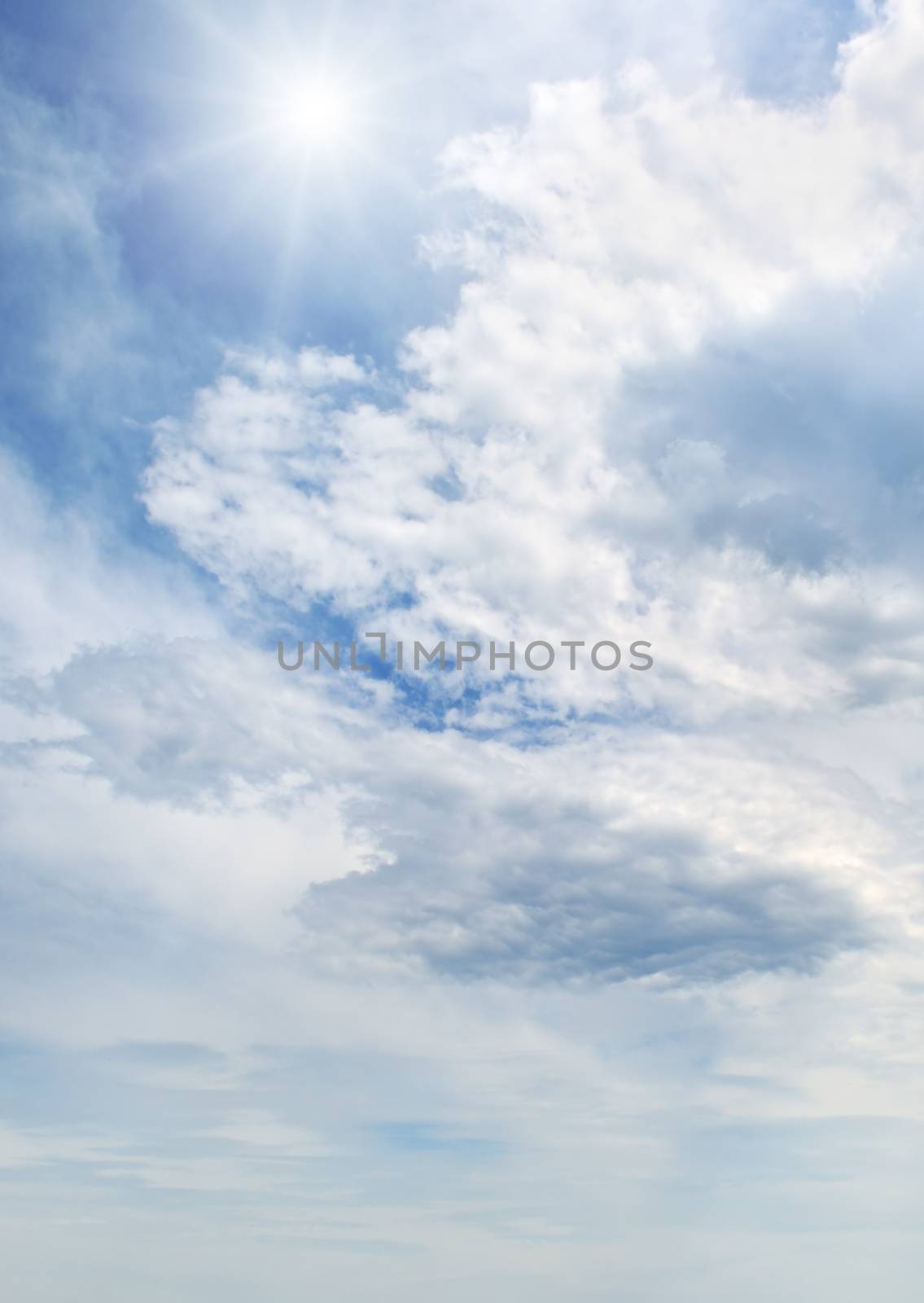   sun on blue sky with white clouds                                 