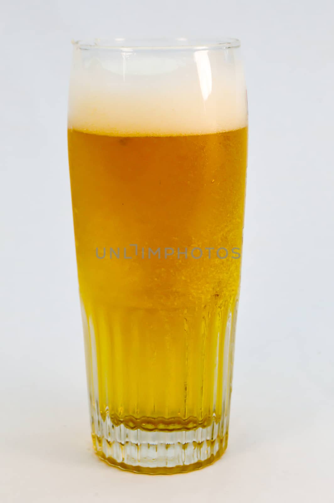 Glass of cold beer on white background