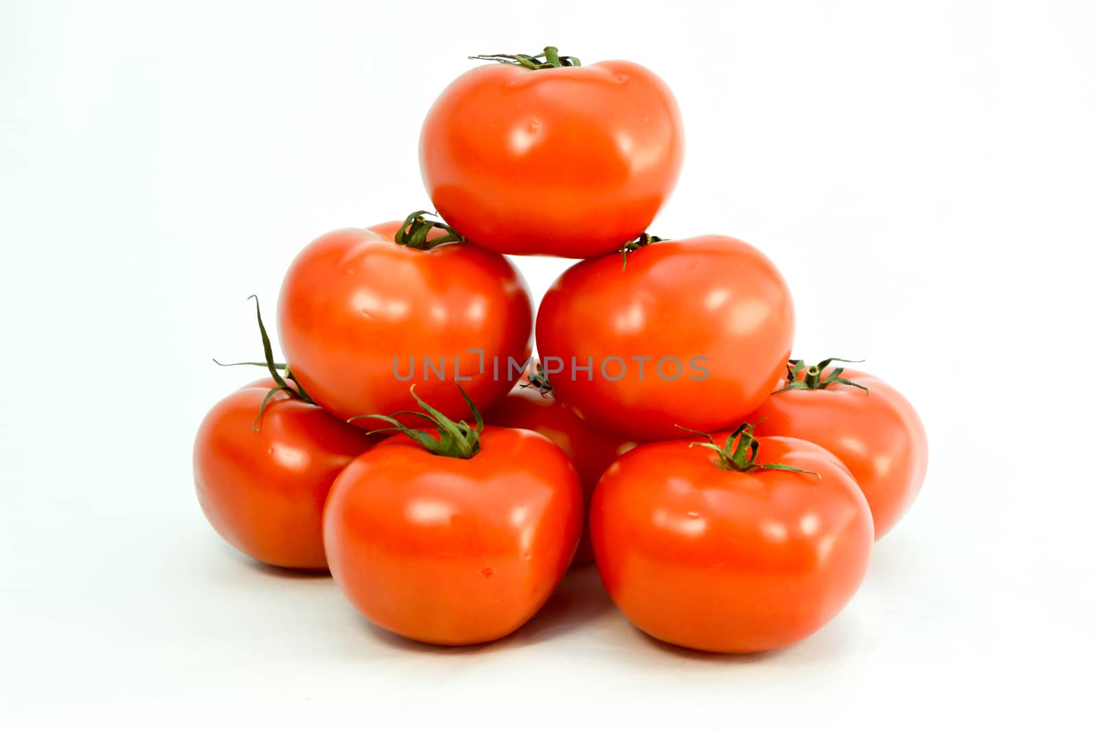 Tomato pyramid well red on white background
