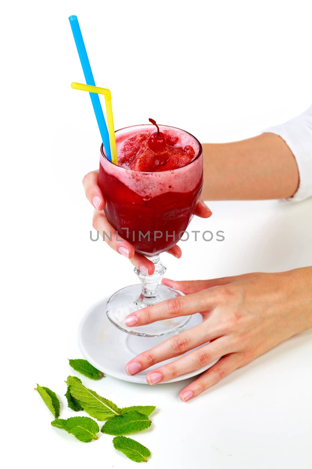 Closeup shot of a cherry smoothie in a big glass cup with two straws in woman's hands. Isolated on white background. Lady with a drink
