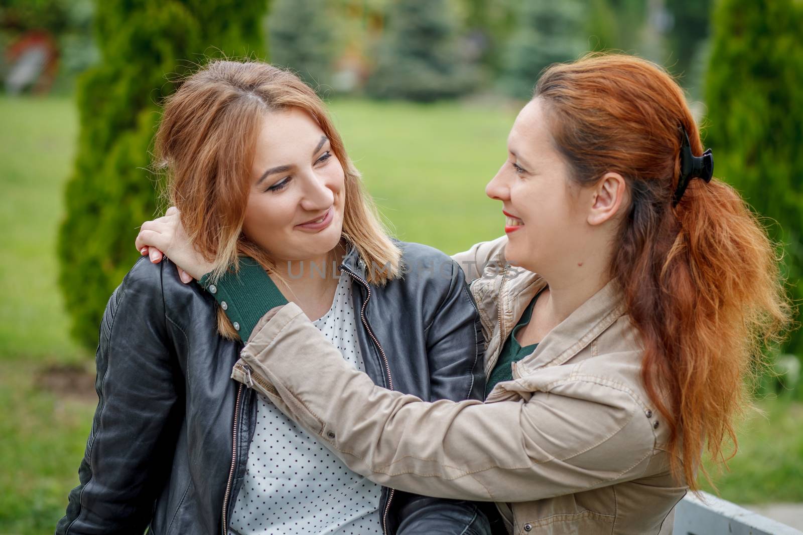 Mother with daughter hugging in park by Angel_a