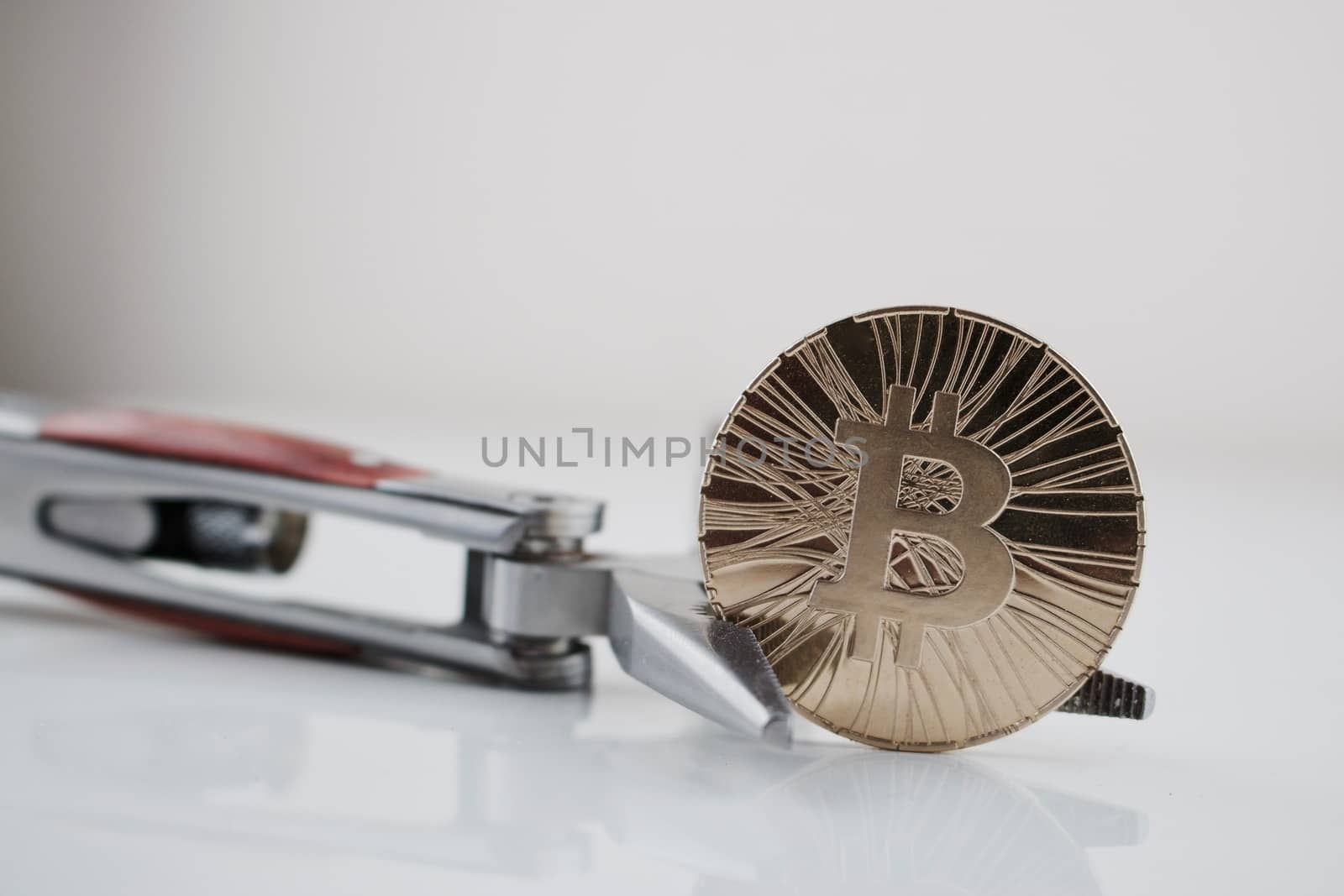 Cryptocurrency physical gold bitcoin coin and pocket knife. Men's toys.