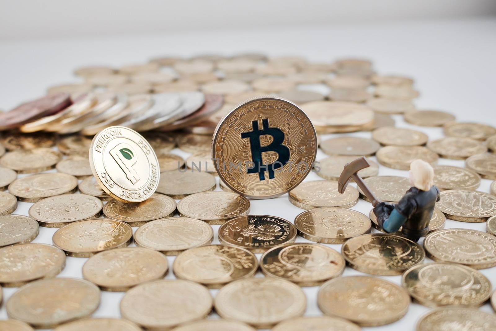 Digital currency physical gold bitcoin and peercoin near miner on the money.
