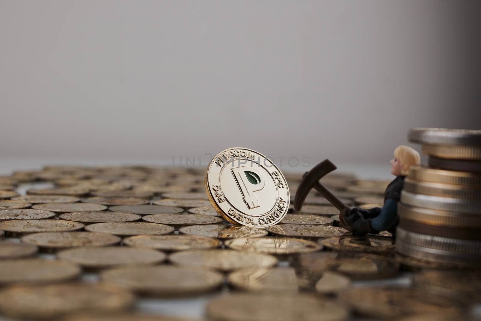 Cryptocurrency physical gold peercoin coin near miner and big money.